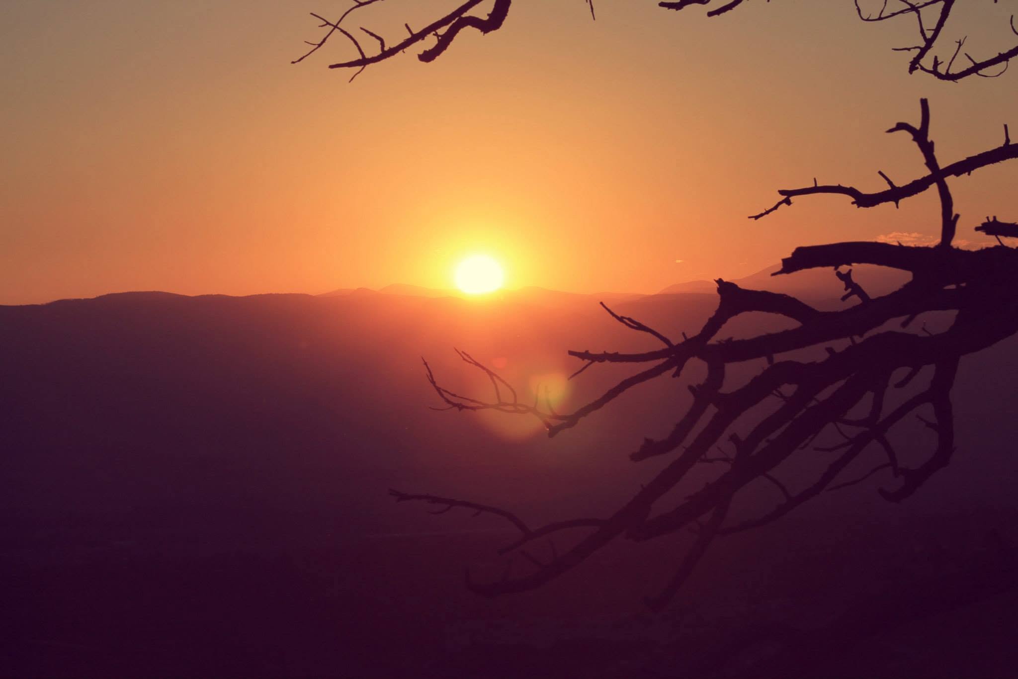 Orange sunset over layered Colorado mountains