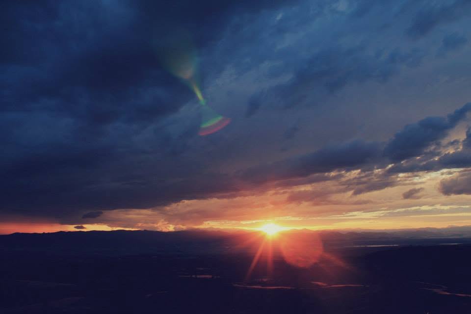 Sunset beneath a dramatic blue storm sky